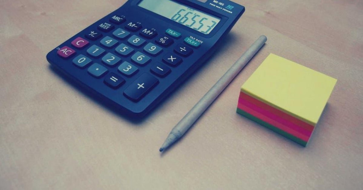 A calculator and figures on a desk