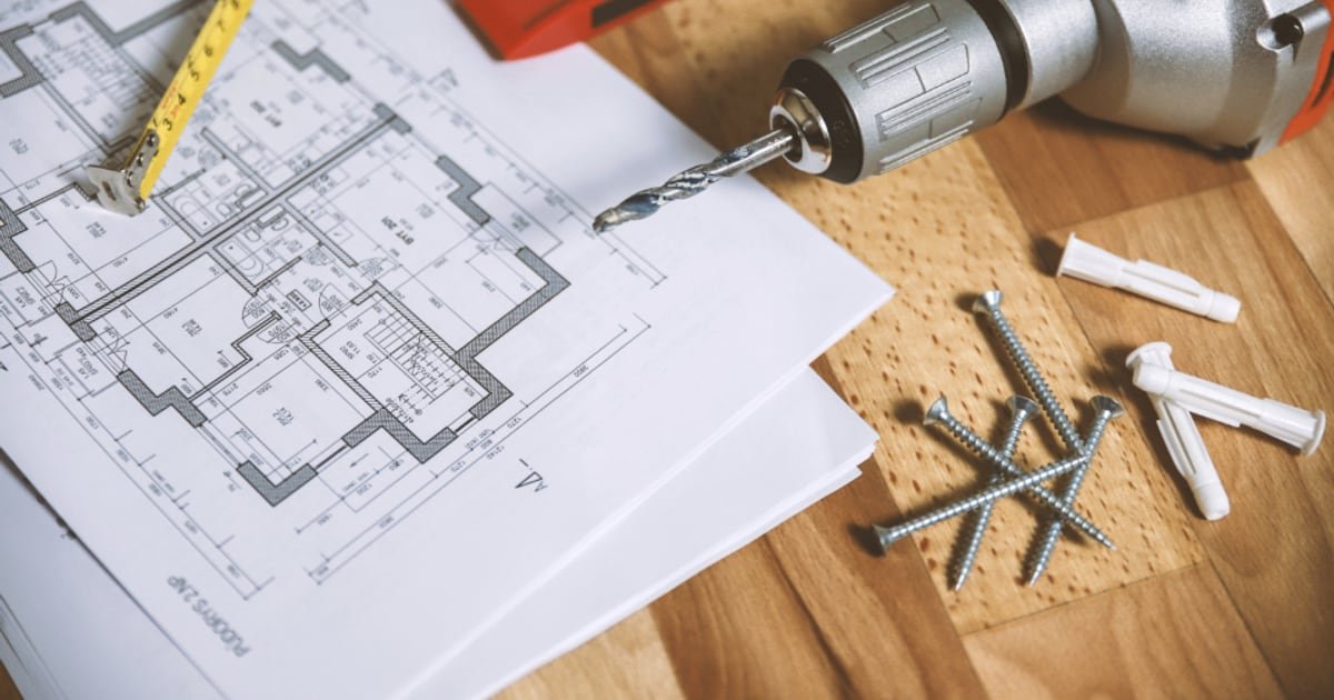 A floor plan on a workshop table